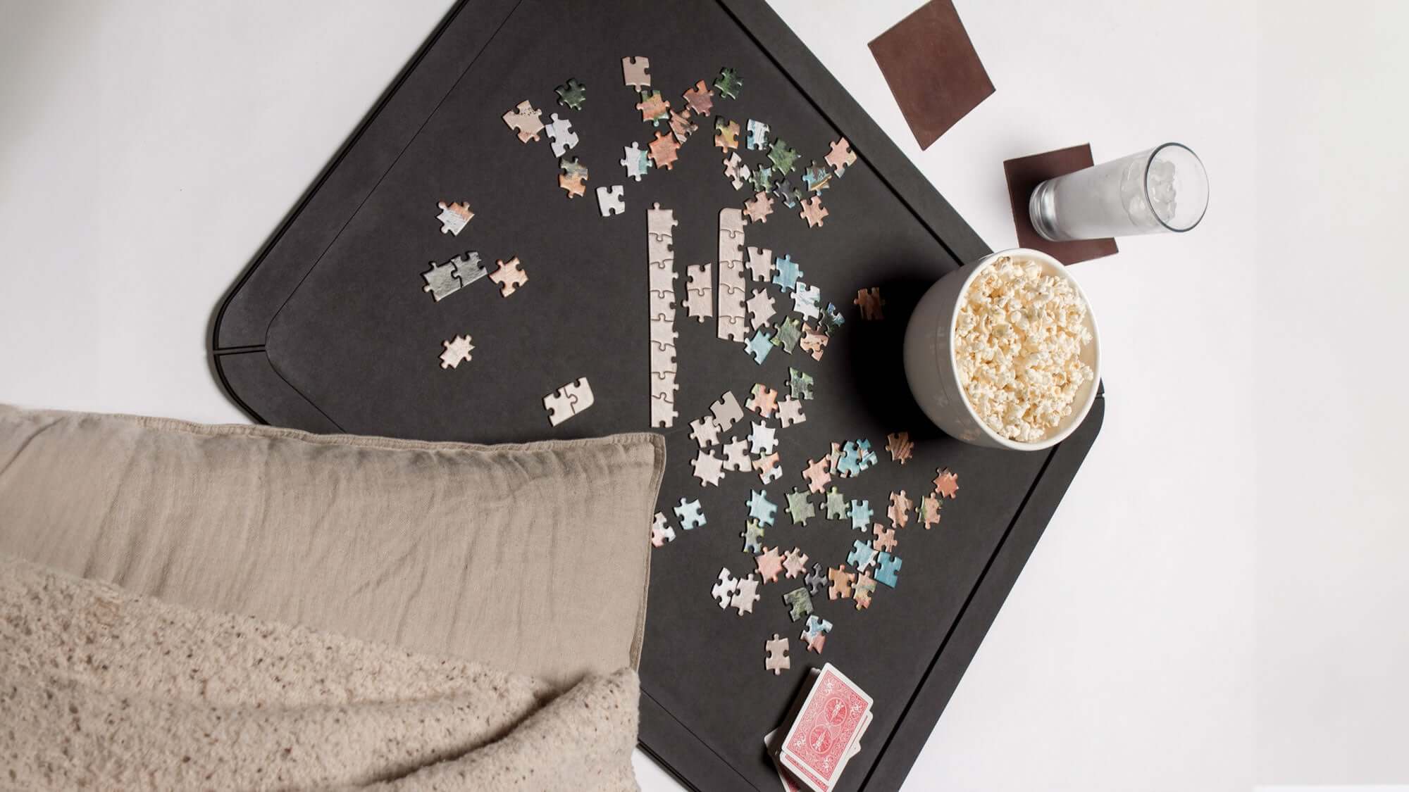 The Epicurean Board Game Board shown with Jigsaw puzzle pieces