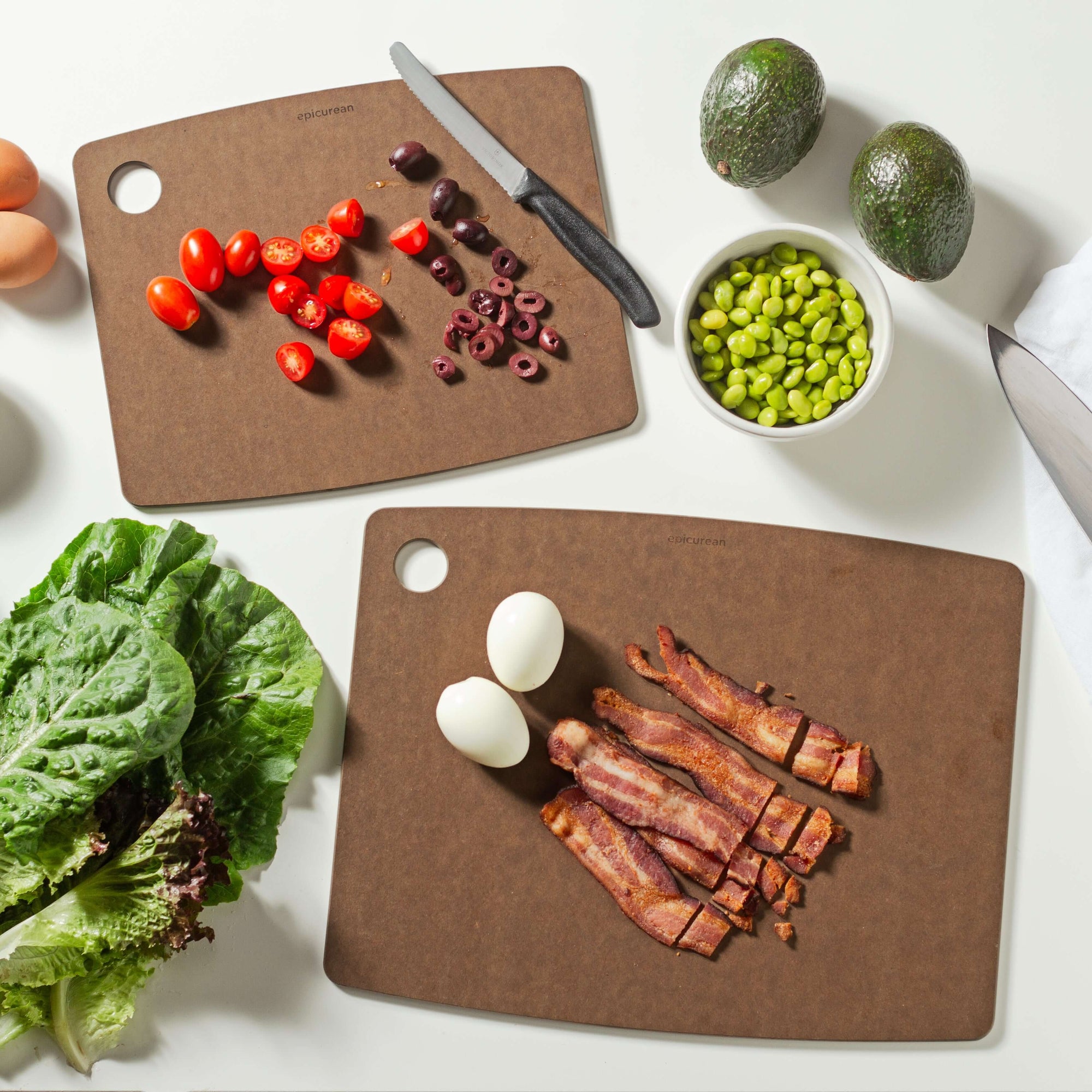 Epicuren Kitchen Series Cutting Board Set in Nutmeg sizes 14.5 inches by 11.25 inches and 11.5 inches by 9 inches ready to support your culinary adventures by slicing assorted vegetables and proteins.