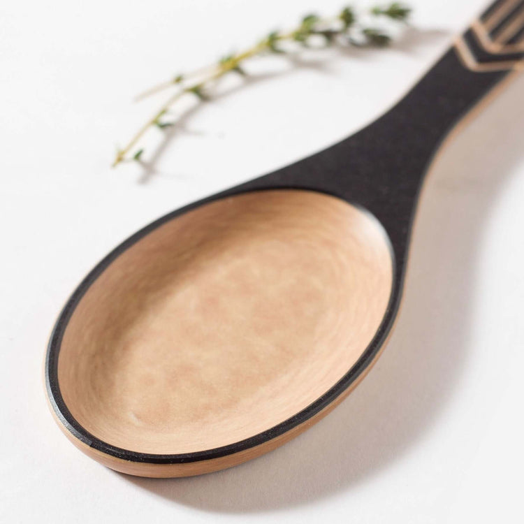 The Frank Lloyd Wright Utensil Set includes the Large Spoon, Paddle and Sauté Tool in Slate/Natural this is a close up detail of the spoon