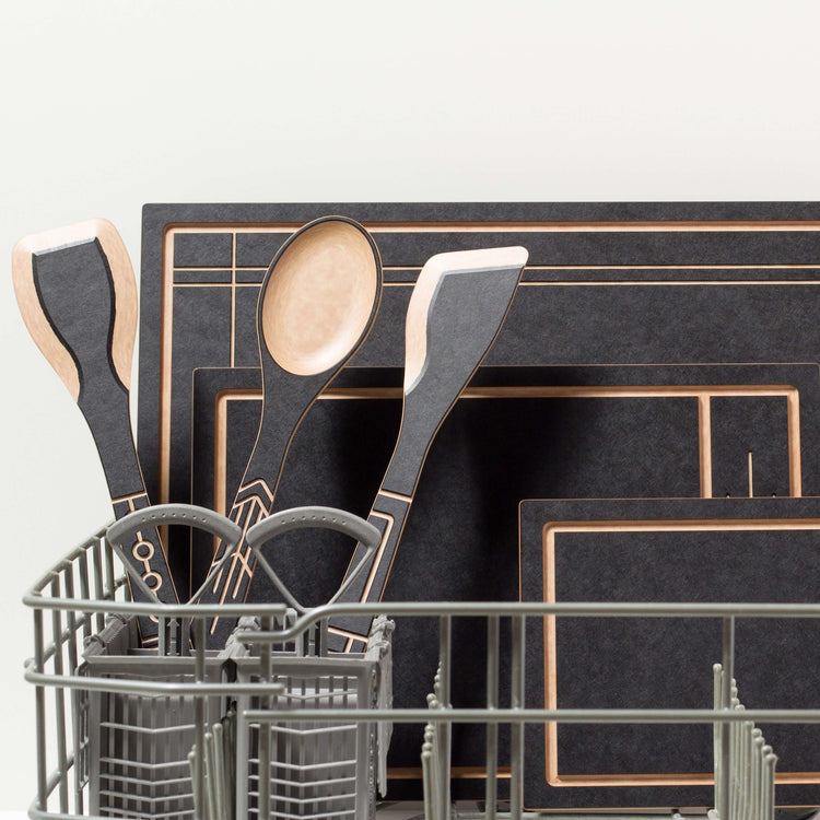 The Frank Lloyd Wright Collection featuring Cut and Serve Small, Medium and Large Boards, Saute Tool, Large Spoon & Paddle in Slate/Natural placed in the dishwasher