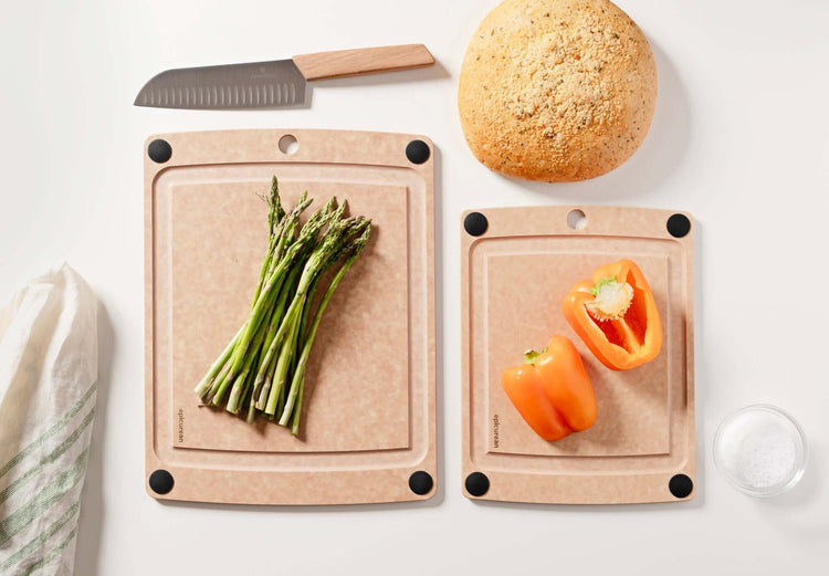 Up close detail of the All-in-One Cutting Board Set in Natural ready for meal prep with fresh asparagus and peppers ready to be expertly chopped with a Victorinox Swiss Modern Chef's knife with wood handle