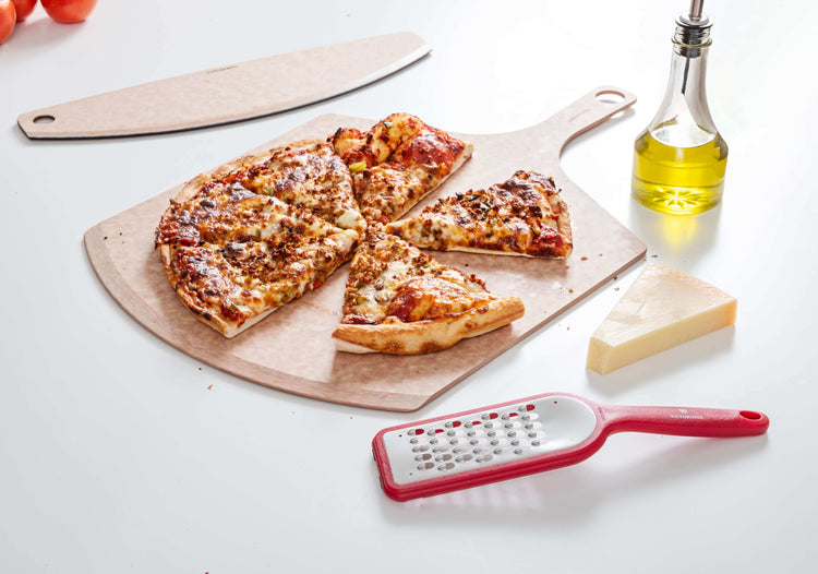 Epicurean Pizza Peel & Pizza Cutter Combo in Natural with a delicious homemade pizza which has been sliced and enjoyed
