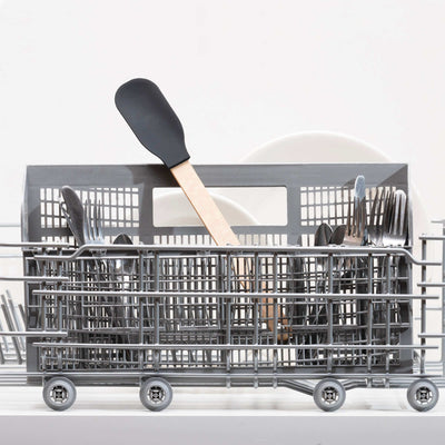 Epicurean Silicone Series Natural/Black Small Spoonula sitting in a dishwasher silverware basket