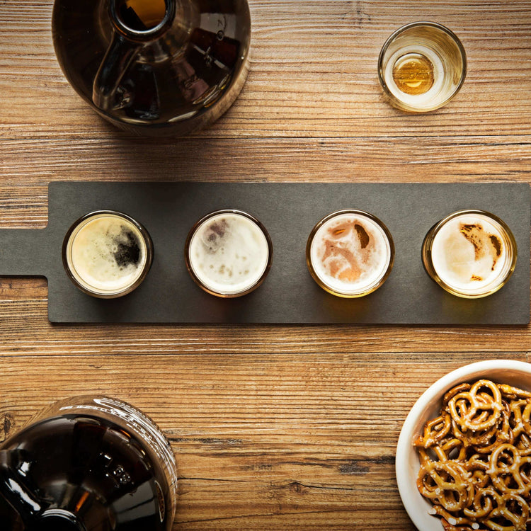 Flight Server Large filled with beer tasting on a walnut bar with growlers and pretzels