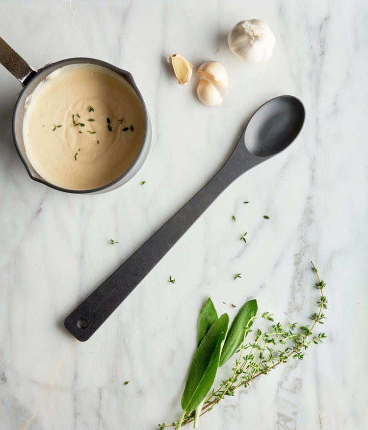 Slate Chef's Series Small Spoon on a marble counter with alfredo sauce in a pan